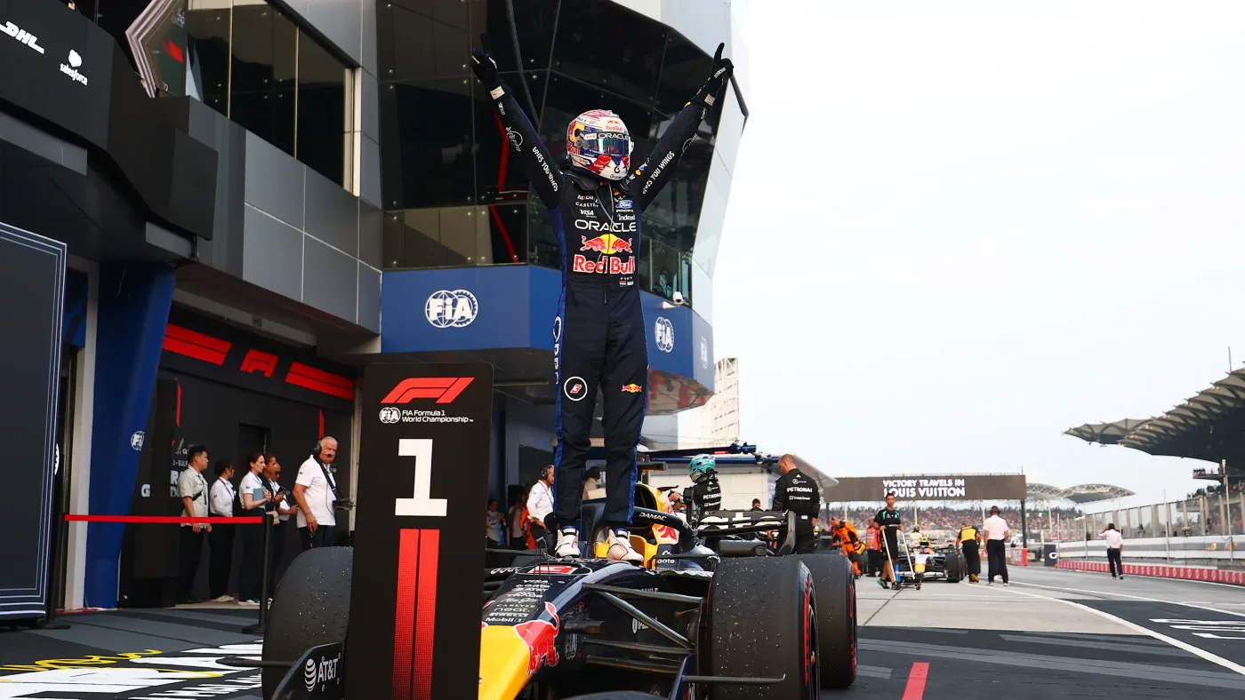 Max Verstappen standing on top of his Red Bull with both arms raised after winning the 2026 Bahrain Grand Prix in Malaysia.